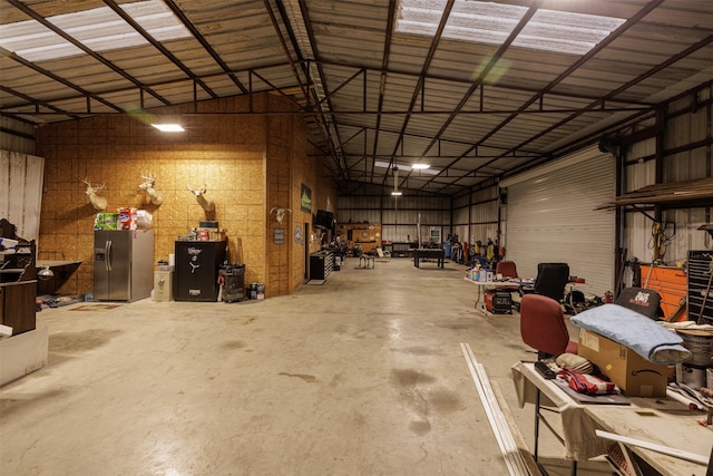 garage with stainless steel refrigerator with ice dispenser