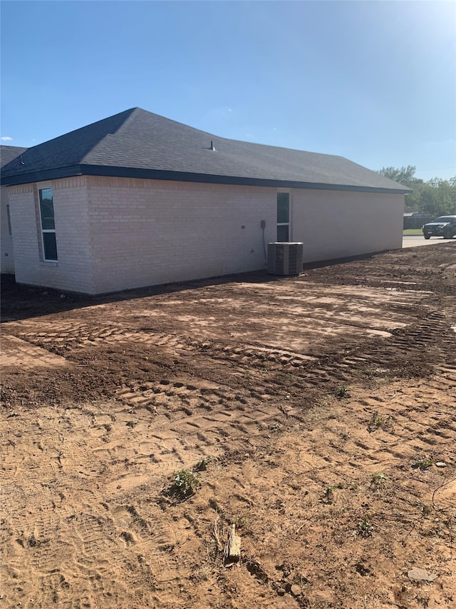 back of property featuring central AC unit