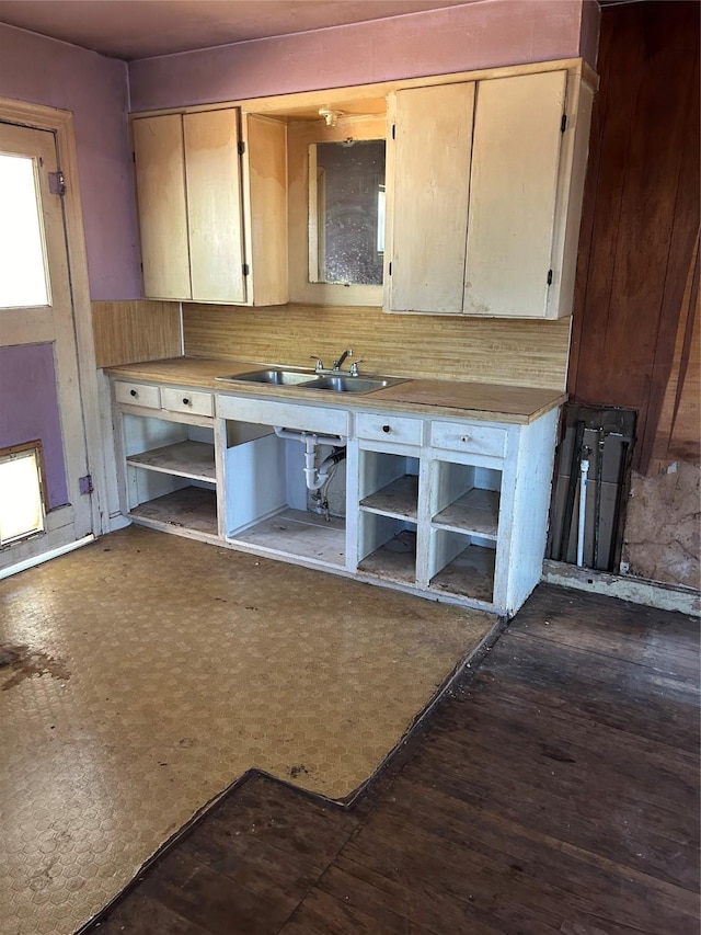 kitchen with tasteful backsplash, sink, and light brown cabinets