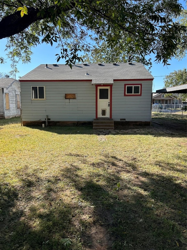 back of property with a lawn