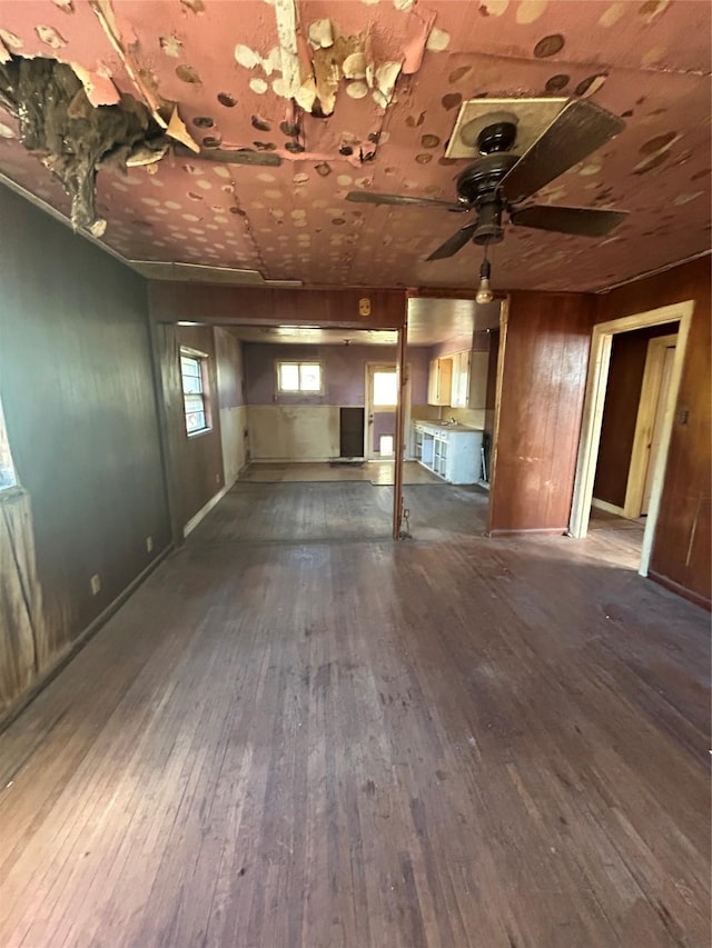 interior space with dark wood-type flooring and ceiling fan