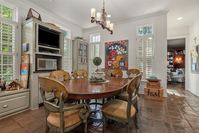 tiled dining space with ornamental molding, a chandelier, and a healthy amount of sunlight