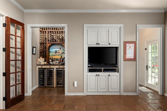 interior space with wine cooler, ornamental molding, and bar