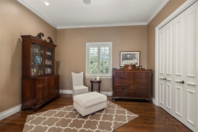 living area featuring ornamental molding and dark hardwood / wood-style flooring