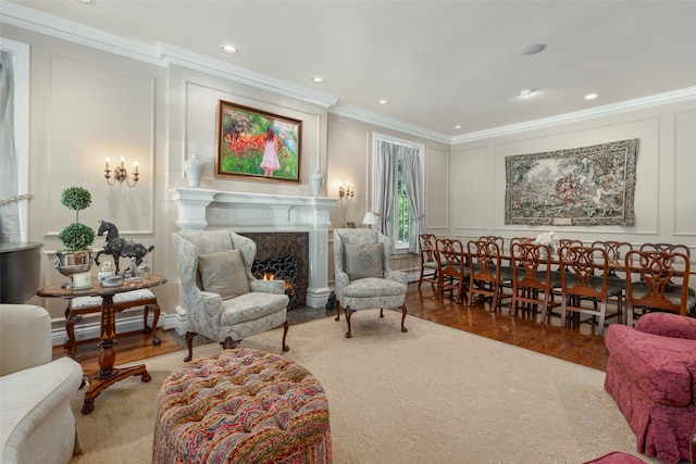 sitting room featuring ornamental molding and hardwood / wood-style floors