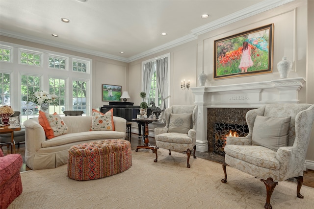 living area with crown molding, a premium fireplace, and light hardwood / wood-style flooring