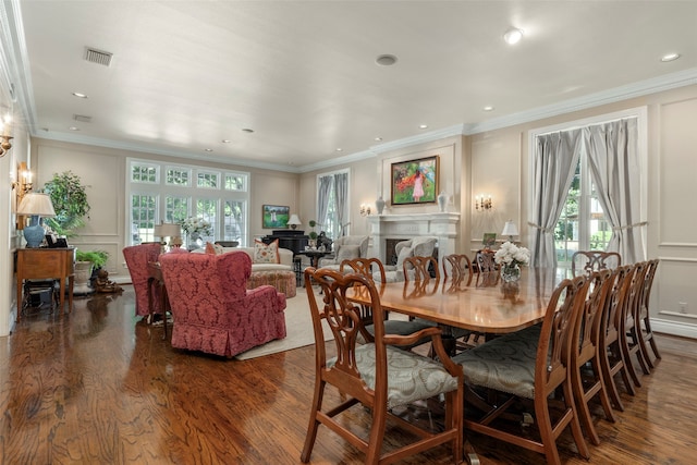 dining area with crown molding, dark wood-type flooring, and a wealth of natural light