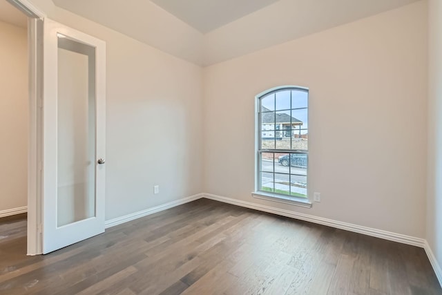 empty room featuring dark wood-type flooring