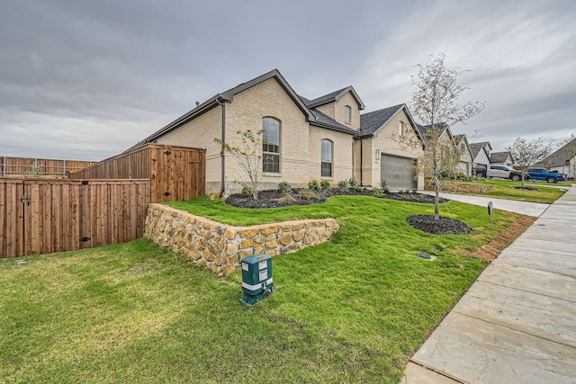 view of front of house featuring a front yard and a garage