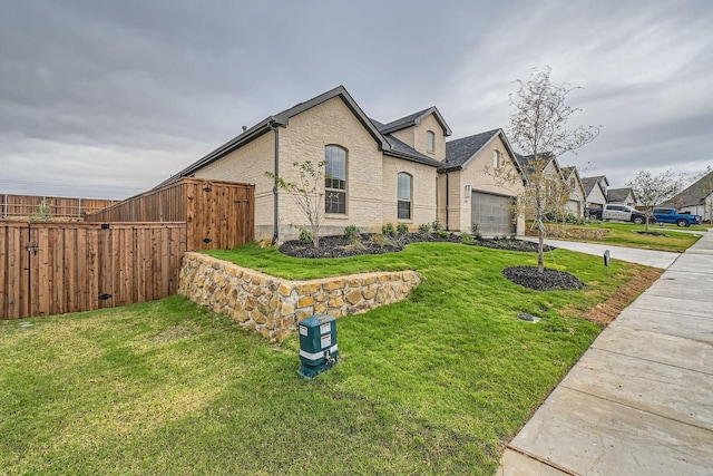 view of front of home with a garage and a front yard