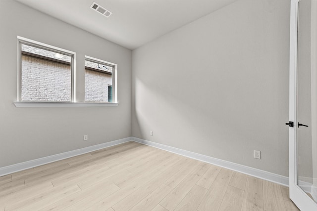 unfurnished room with light hardwood / wood-style flooring