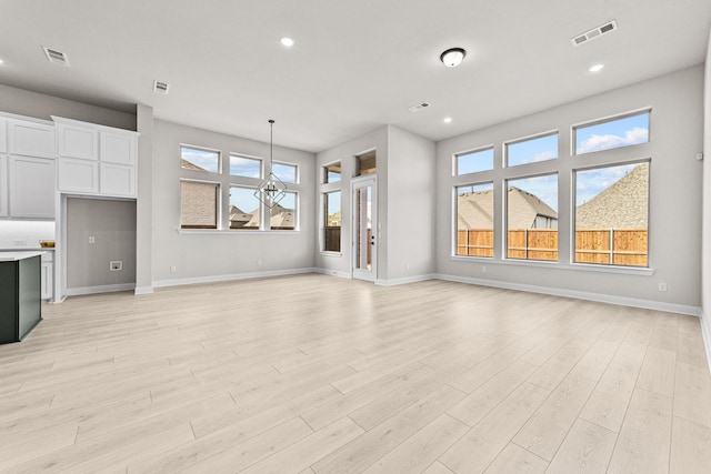 unfurnished living room with light hardwood / wood-style flooring