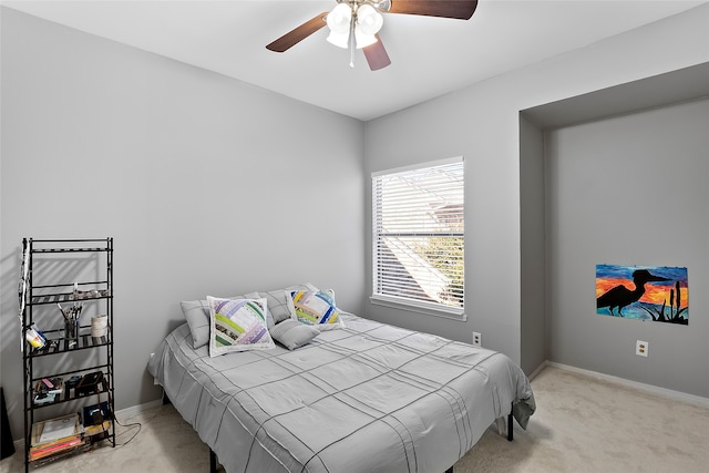 bedroom with light carpet and ceiling fan