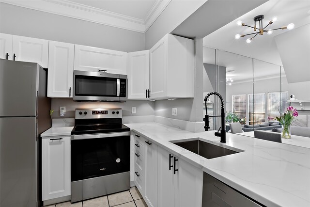 kitchen featuring sink, white cabinets, light tile patterned floors, appliances with stainless steel finishes, and light stone counters