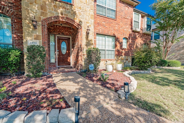 property entrance with a lawn