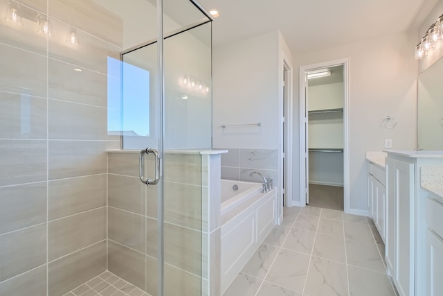 bathroom featuring vanity and shower with separate bathtub