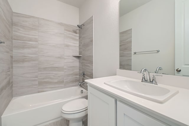 full bathroom featuring toilet, vanity, and tiled shower / bath