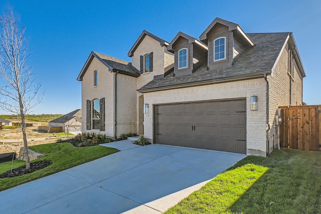 view of front of home featuring a garage and a front lawn