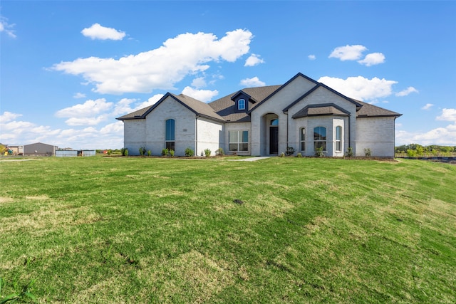 french country home with a front lawn