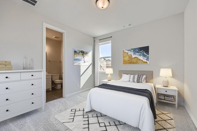 carpeted bedroom featuring connected bathroom