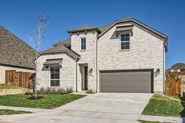 view of front of property featuring a garage and a front yard