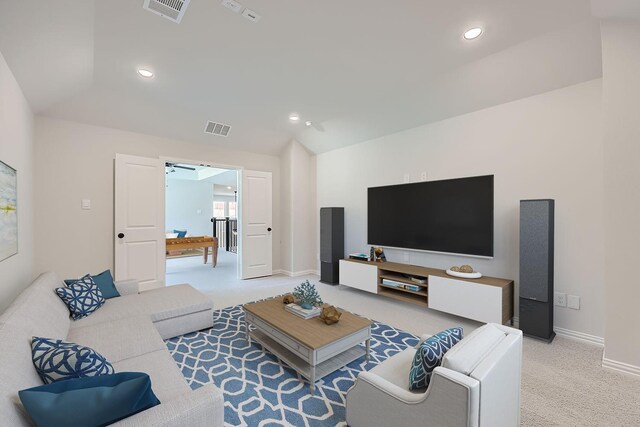 carpeted living room featuring vaulted ceiling