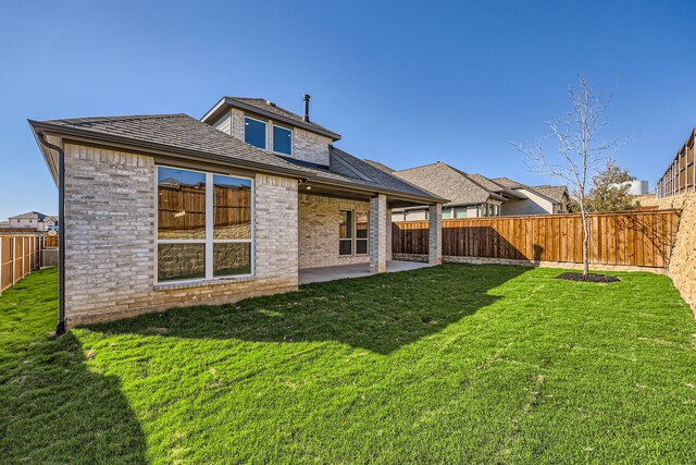 back of house with a yard and a patio area