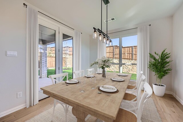 dining space with light wood-type flooring