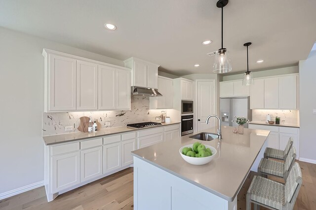 kitchen with white cabinetry, sink, a center island with sink, and appliances with stainless steel finishes