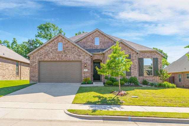 view of front of home with a garage and a front yard