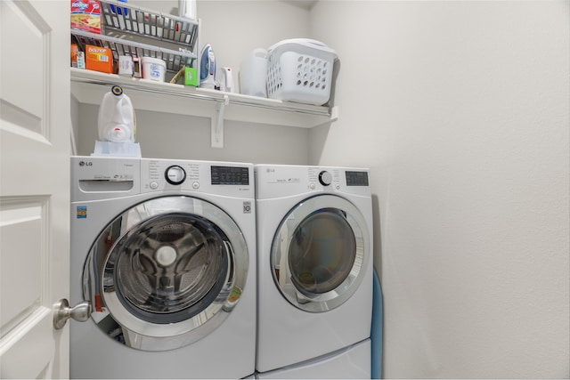 clothes washing area featuring washing machine and dryer