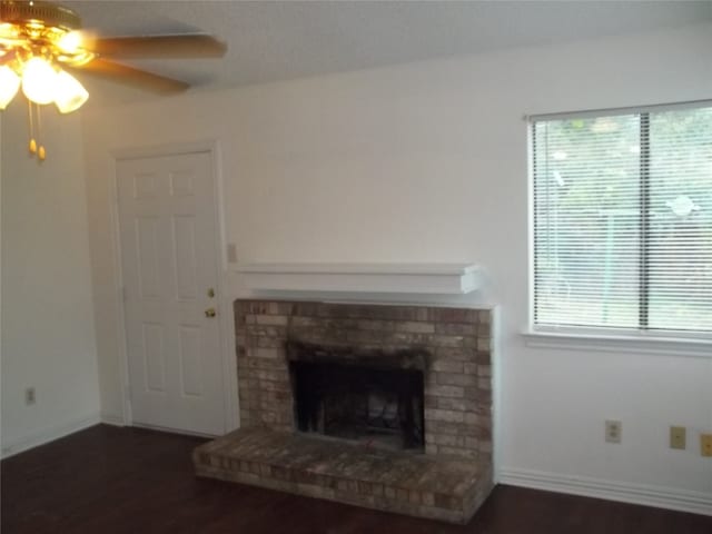 unfurnished living room featuring ceiling fan and dark hardwood / wood-style floors