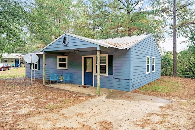 bungalow-style home with metal roof