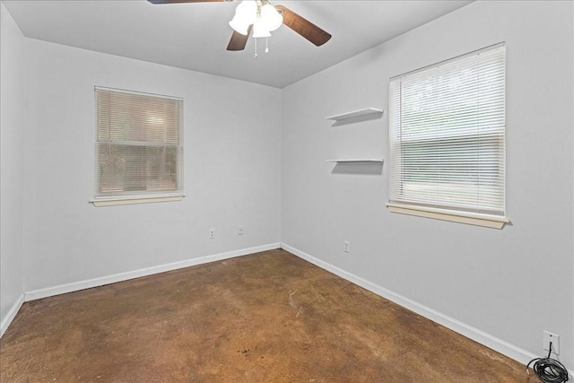 unfurnished room featuring ceiling fan, concrete floors, and baseboards