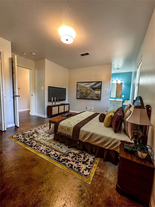 bedroom featuring visible vents, a textured ceiling, and baseboards