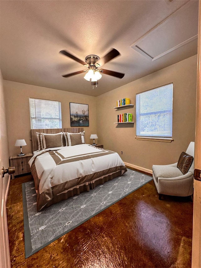 bedroom featuring concrete floors, baseboards, and a ceiling fan