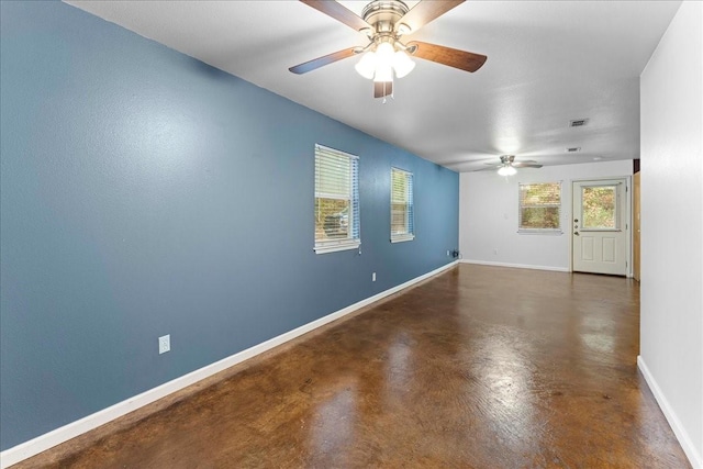 empty room with visible vents, finished concrete flooring, and baseboards