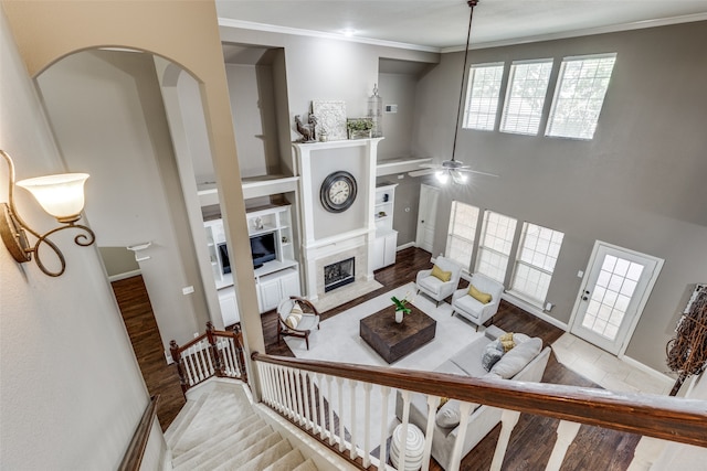 living room featuring ceiling fan, crown molding, and hardwood / wood-style floors