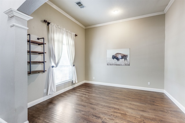 empty room featuring ornamental molding and dark hardwood / wood-style flooring