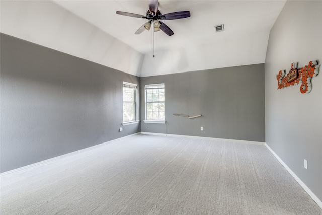 carpeted empty room featuring high vaulted ceiling and ceiling fan