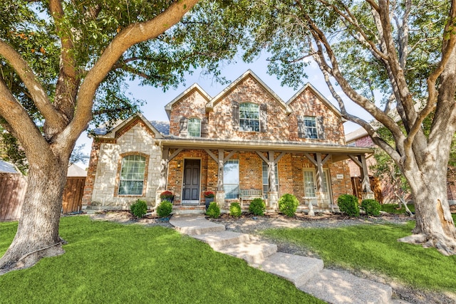 view of front facade with a front yard and covered porch