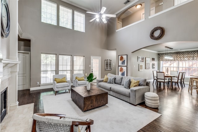 living room featuring ceiling fan, a high ceiling, plenty of natural light, and hardwood / wood-style floors