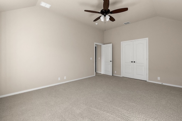 unfurnished bedroom with carpet, vaulted ceiling, a closet, and ceiling fan