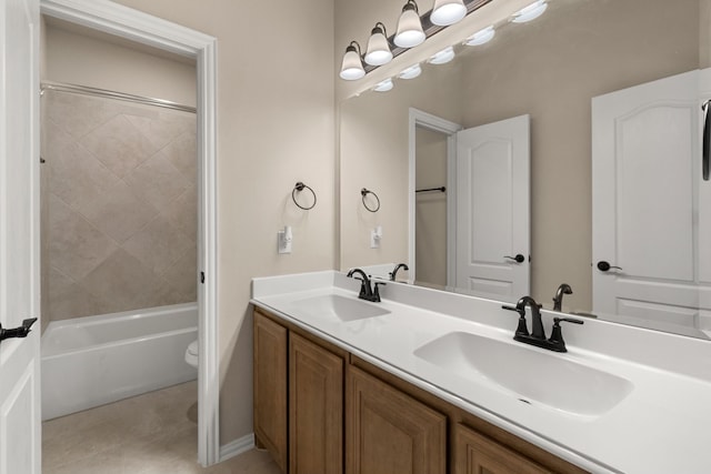 full bathroom with vanity, toilet, and tiled shower / bath