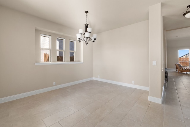 empty room featuring an inviting chandelier, a healthy amount of sunlight, and light tile patterned floors