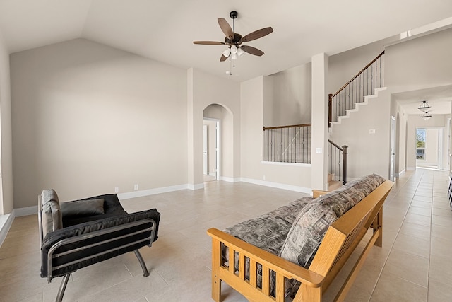 living room with vaulted ceiling, ceiling fan, and light tile patterned floors