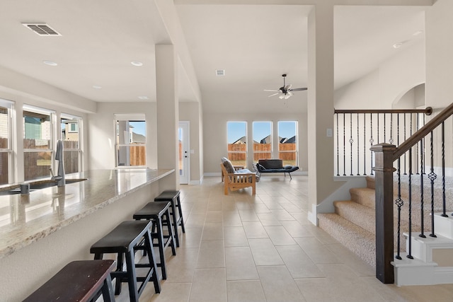 interior space featuring a wealth of natural light, ceiling fan, and tile patterned flooring