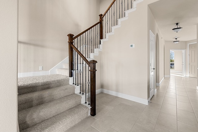 stairs with tile patterned floors