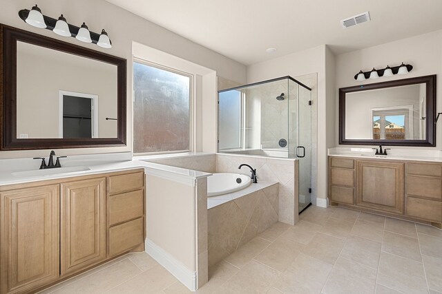 bathroom featuring vanity, independent shower and bath, and tile patterned floors