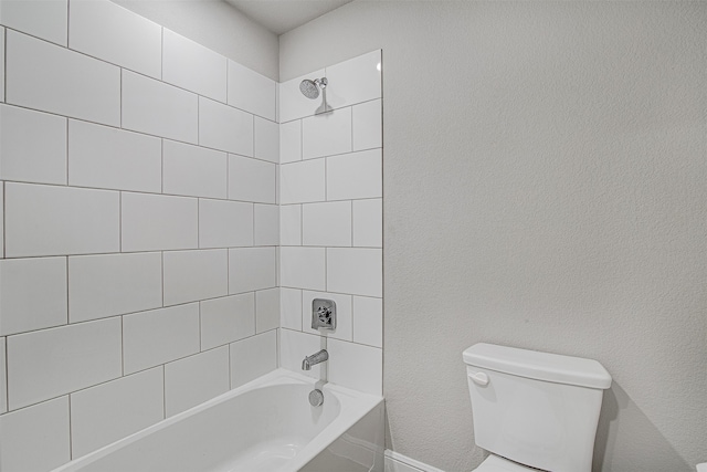 bathroom featuring toilet and tiled shower / bath combo